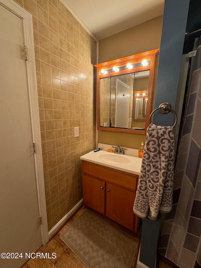 bathroom with vanity, tile walls, and tile patterned flooring