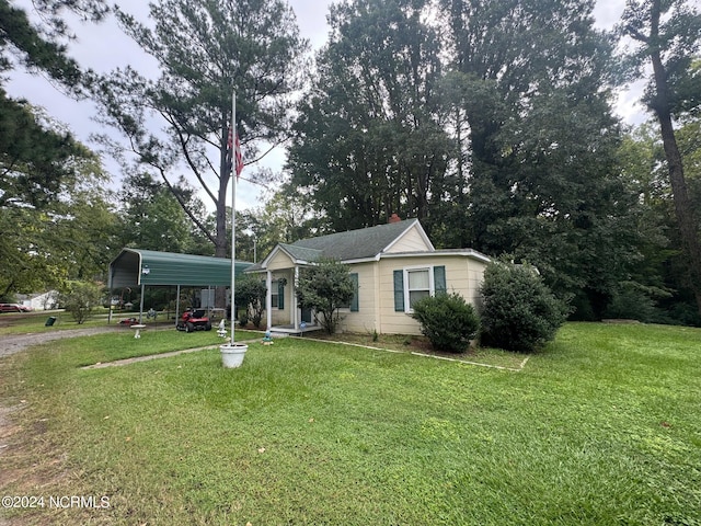 view of front facade with a front yard and a carport