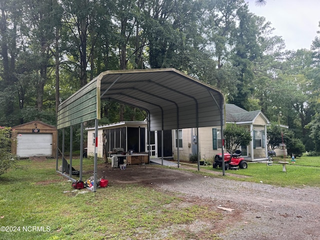 exterior space with a lawn, a carport, and a garage