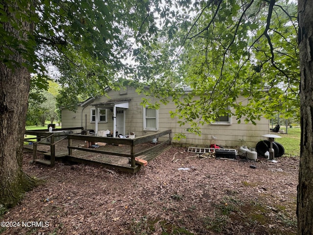 back of house with a deck