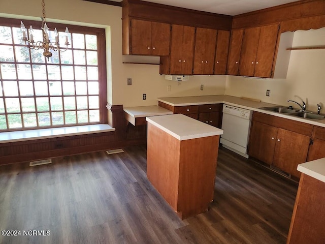 kitchen with a healthy amount of sunlight, hanging light fixtures, a center island, and dishwasher