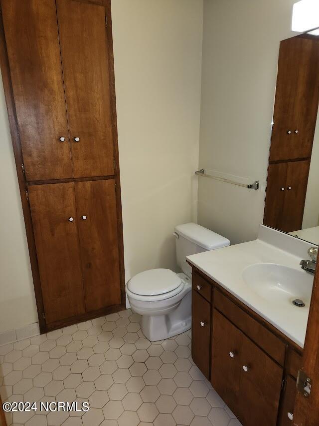 bathroom featuring vanity, toilet, and tile patterned floors