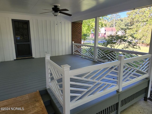 wooden terrace featuring ceiling fan