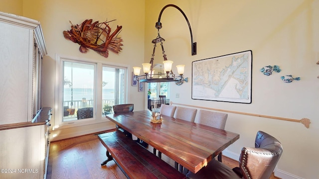 dining area featuring hardwood / wood-style floors and an inviting chandelier