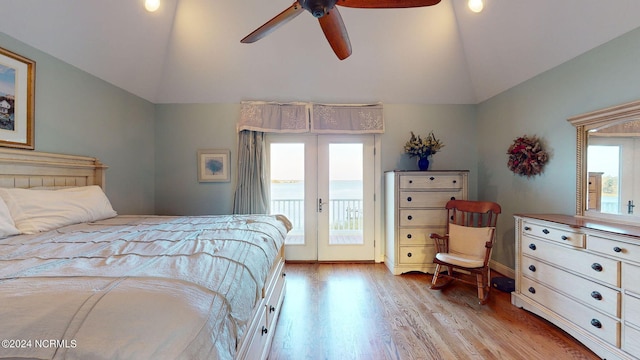 bedroom with ceiling fan, wood finished floors, access to outside, vaulted ceiling, and french doors