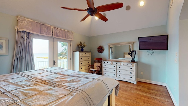 bedroom featuring light wood finished floors, baseboards, access to exterior, vaulted ceiling, and french doors