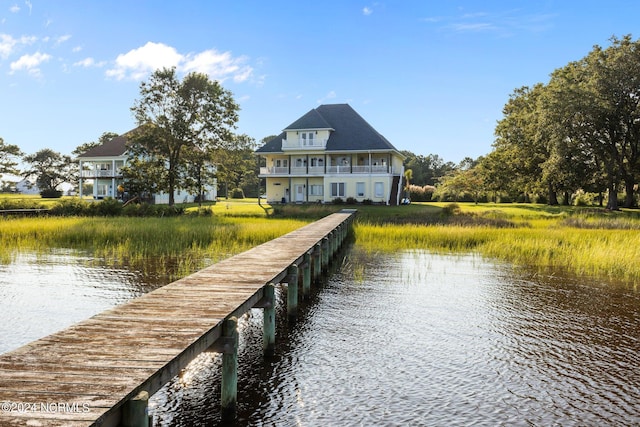 view of dock with a water view and a balcony