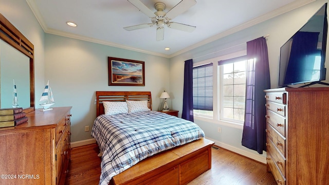 bedroom featuring ornamental molding, wood-type flooring, and ceiling fan