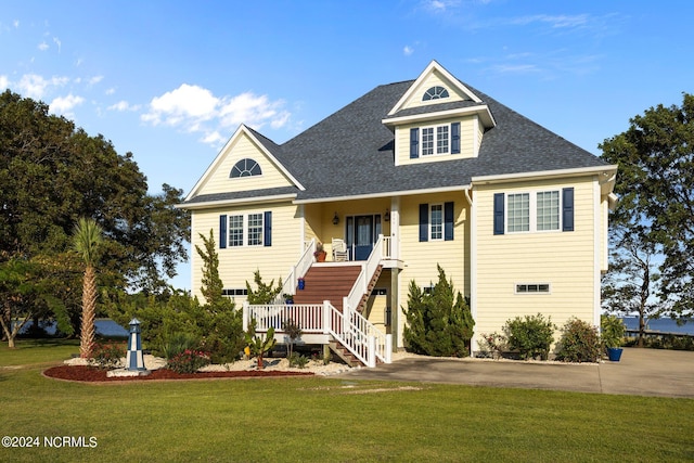 view of front of home featuring covered porch and a front yard