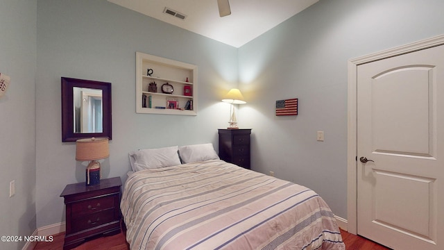 bedroom with dark hardwood / wood-style flooring, ceiling fan, and lofted ceiling