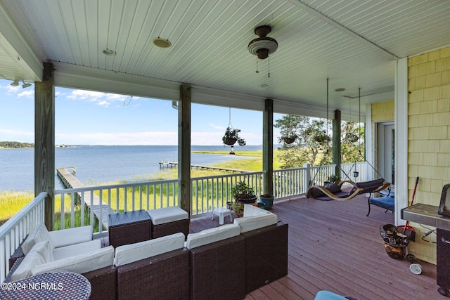 wooden terrace featuring a water view and outdoor lounge area