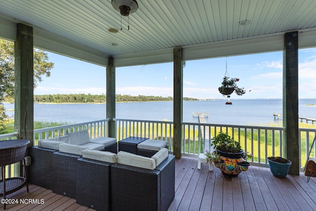 wooden terrace featuring a water view and an outdoor hangout area