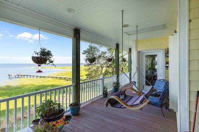 wooden deck featuring a water view