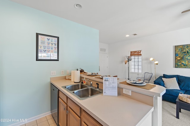 kitchen with dishwasher, sink, and light tile patterned flooring