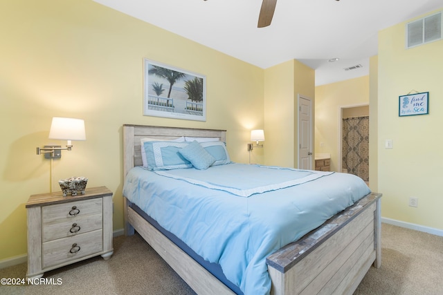 bedroom with carpet flooring, ceiling fan, and ensuite bathroom