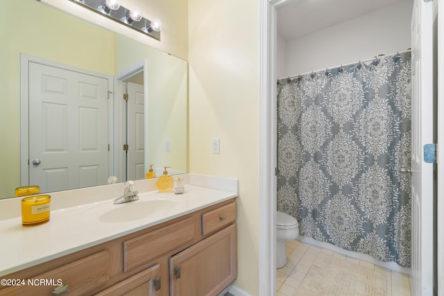 bathroom featuring tile patterned floors, vanity, and toilet