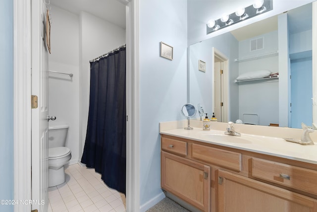 bathroom with tile patterned floors, vanity, and toilet