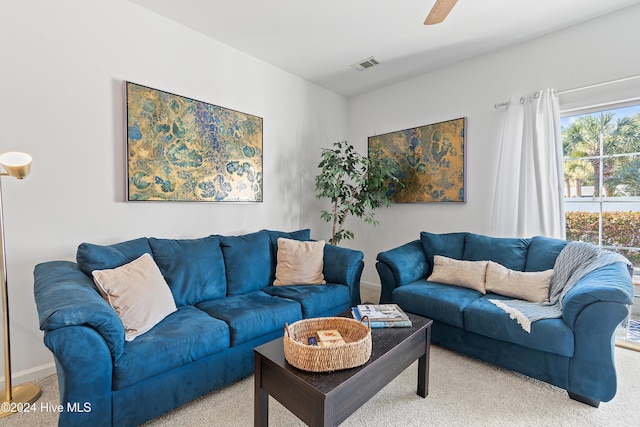 living room featuring carpet and ceiling fan