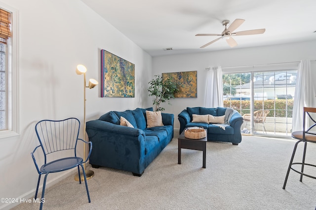 living room with ceiling fan and carpet floors