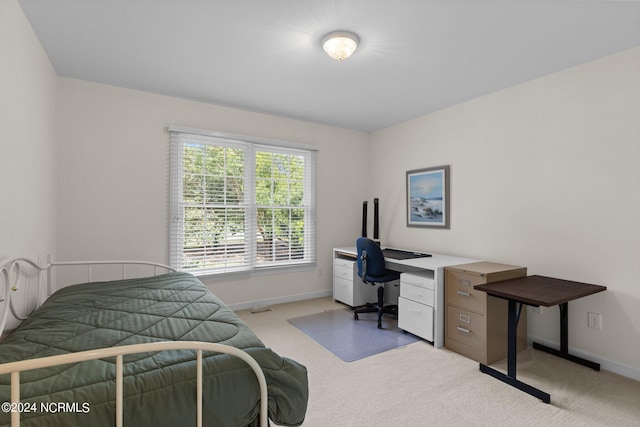 bedroom featuring light carpet