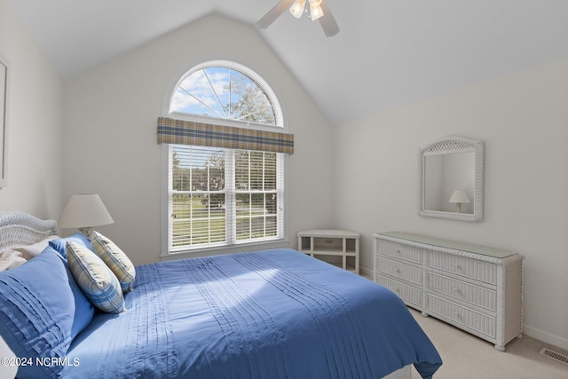 bedroom with lofted ceiling, ceiling fan, light carpet, and multiple windows