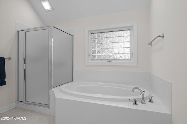 bathroom featuring tile patterned flooring, vaulted ceiling, and plus walk in shower