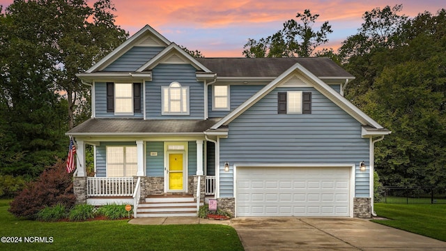 craftsman inspired home with a lawn, a porch, and a garage