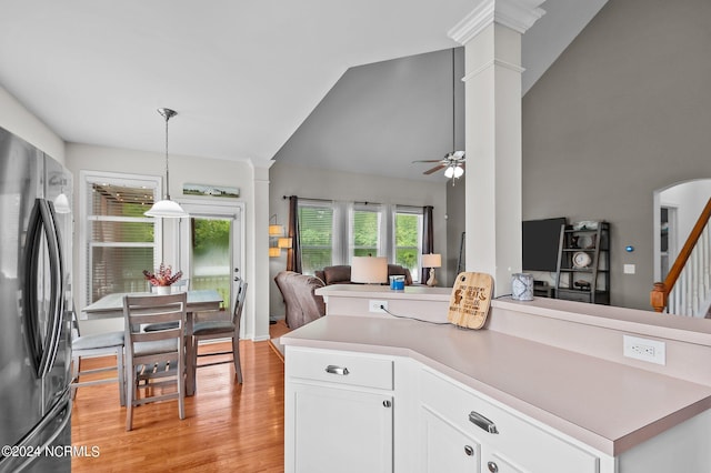 kitchen featuring white cabinets, hanging light fixtures, ceiling fan, kitchen peninsula, and stainless steel refrigerator