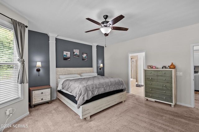 bedroom with light carpet, connected bathroom, and ceiling fan