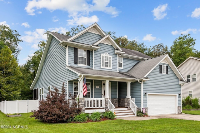 craftsman-style home with a garage, covered porch, and a front lawn