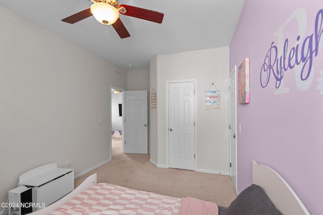 bedroom featuring light colored carpet and ceiling fan