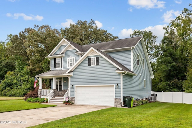 craftsman-style home featuring central AC, a porch, a garage, and a front lawn