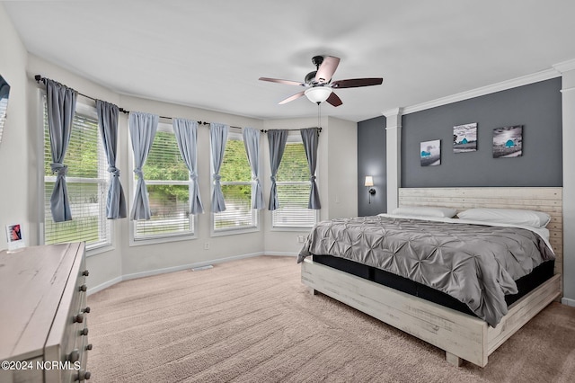 bedroom featuring carpet flooring, ceiling fan, ornamental molding, and multiple windows