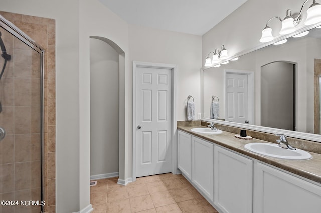 bathroom with tile patterned floors, vanity, and an enclosed shower