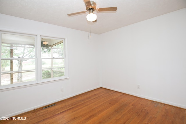 empty room featuring ceiling fan and wood-type flooring