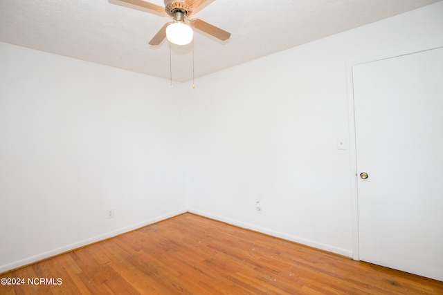 unfurnished room with ceiling fan and hardwood / wood-style flooring