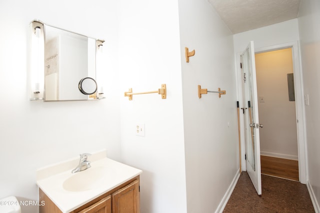 bathroom with a textured ceiling and vanity