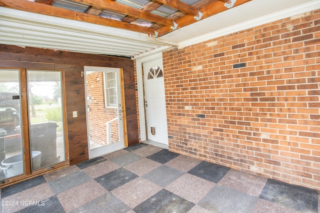 unfurnished sunroom with beam ceiling