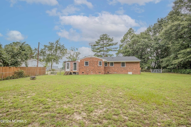 rear view of house with a yard