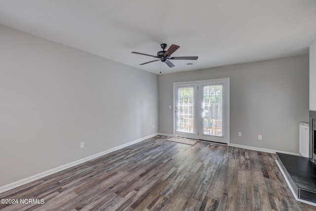 unfurnished living room with ceiling fan and dark hardwood / wood-style flooring