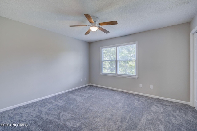 empty room featuring carpet, ceiling fan, and a textured ceiling