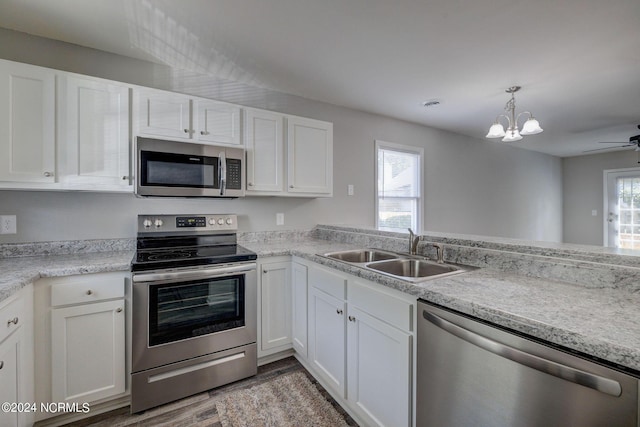 kitchen featuring white cabinets, stainless steel appliances, dark wood-type flooring, and sink