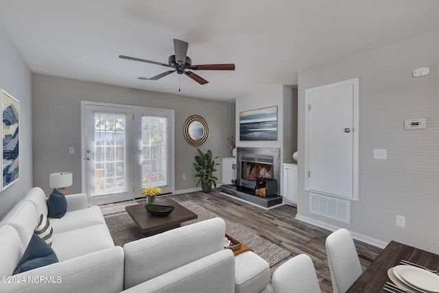 living room featuring dark hardwood / wood-style floors and ceiling fan