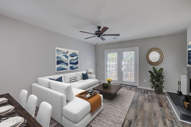 living room featuring ceiling fan and wood-type flooring