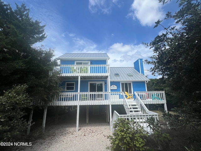 rear view of property featuring a carport