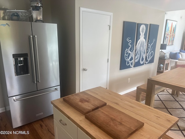 kitchen featuring dark hardwood / wood-style floors and stainless steel fridge