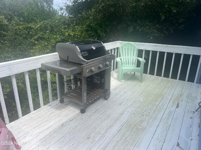 wooden terrace with a grill