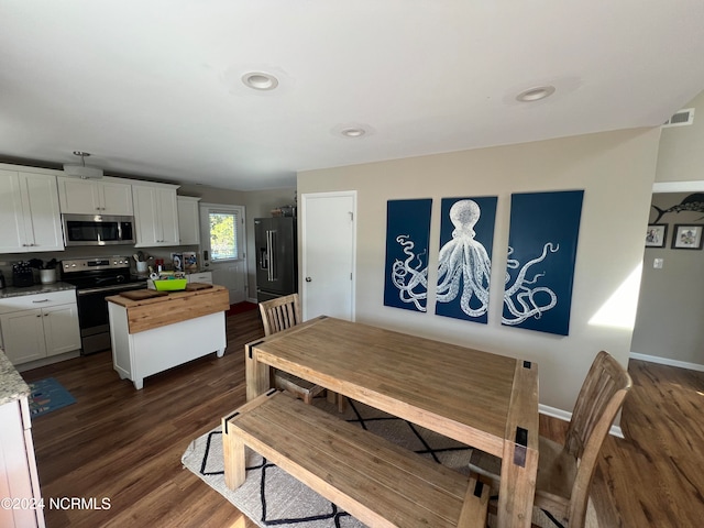 dining room featuring dark hardwood / wood-style flooring