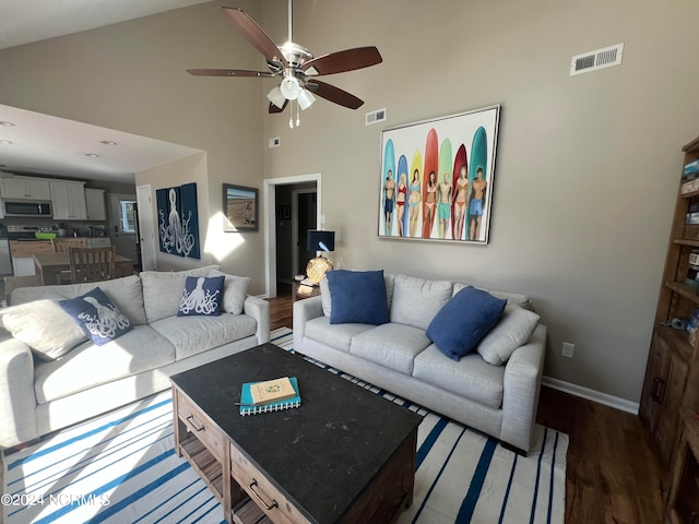 living room featuring high vaulted ceiling, ceiling fan, and dark hardwood / wood-style floors