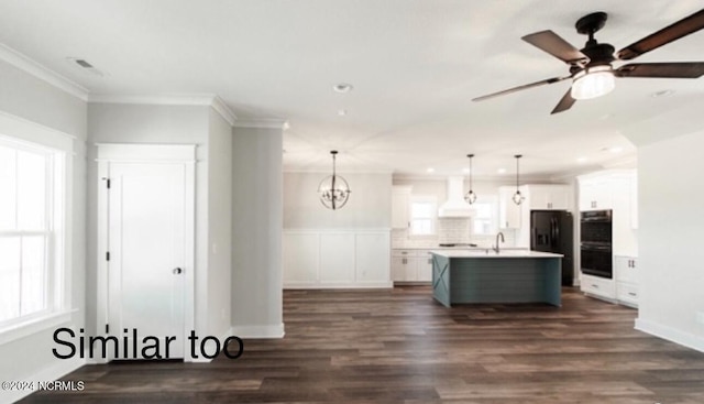 kitchen featuring black appliances, white cabinetry, and crown molding